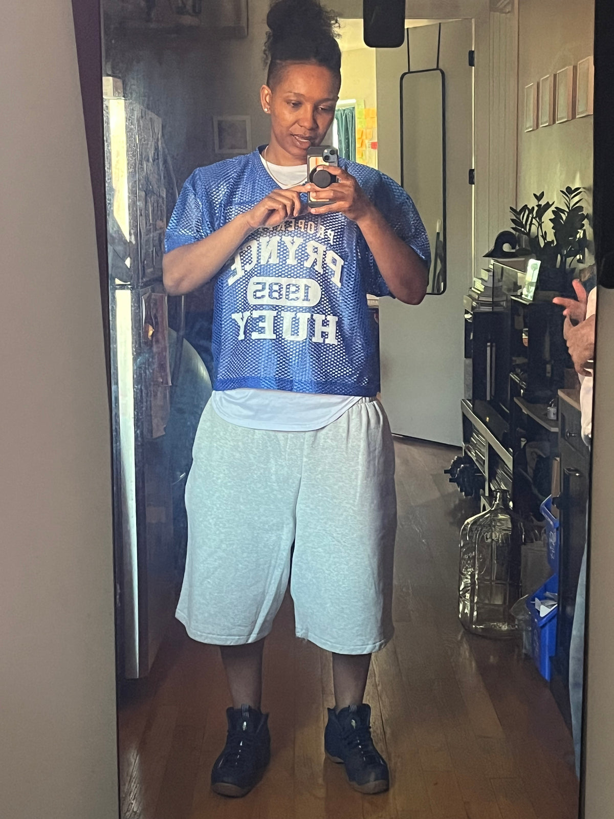 Red '85 Practice Jersey with gold print styled with denim shorts, mirror fit photo